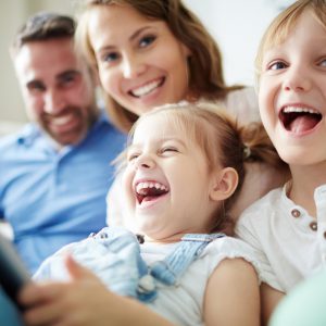 Children sitting together with parents and laughing